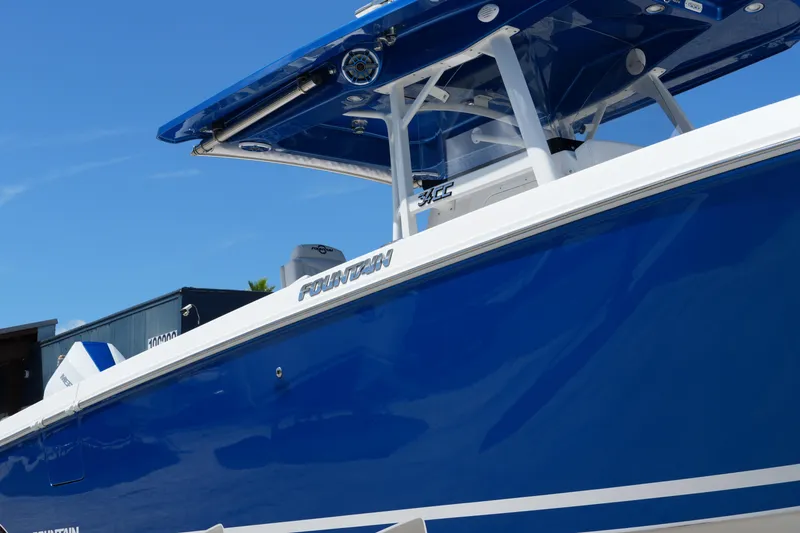 Slide: The Image of 2023 Fountain 34 Center Console boat with sleek blue hull and modern design. - 5
