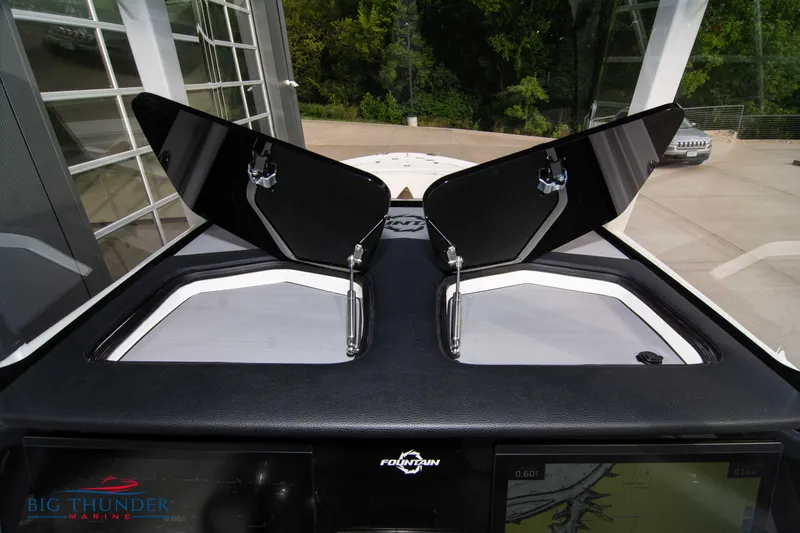 Slide: The Image of 2023 Fountain 34 CC boat dashboard with open hatches, showcasing sleek design and functionality. - 54