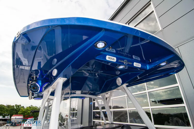 Slide: The Image of 2023 Fountain 34 CC boat with sleek blue canopy and modern design. - 59