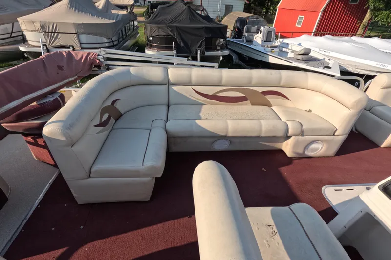 Slide: The Image of 2006 PlayCraft Sunfish 2400 pontoon boat with beige seating and maroon accents. - 10