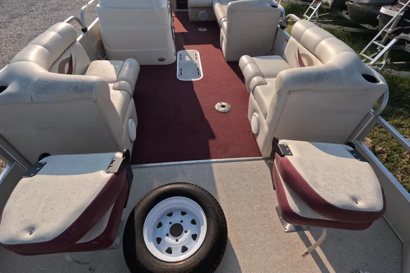 Slide: The Image of 2006 PlayCraft Sunfish 2400 pontoon boat interior with red carpet and seating. - 3