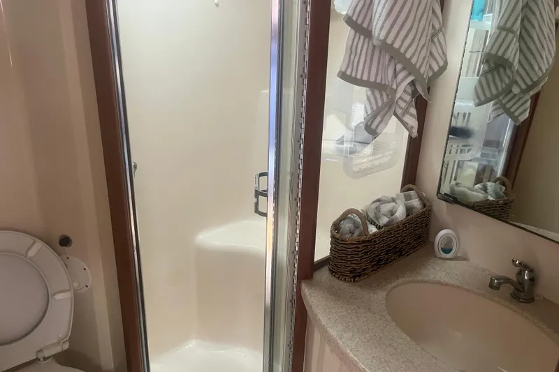 Slide: The Image of Bathroom interior of 1998 Luhrs 36 Open boat with shower, sink, and toilet. - 10