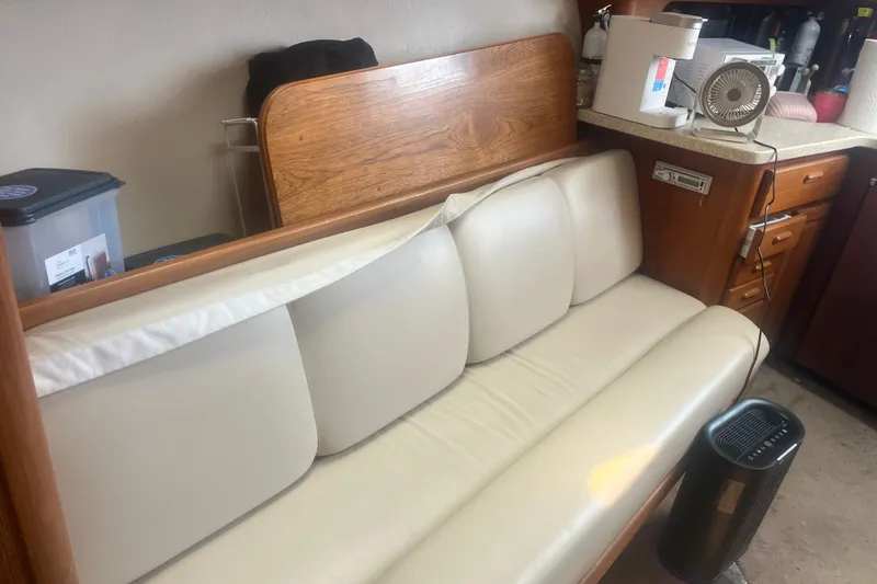 Slide: The Image of Interior of 1998 Luhrs 36 Open boat with cream leather seating and wooden cabinetry. - 12