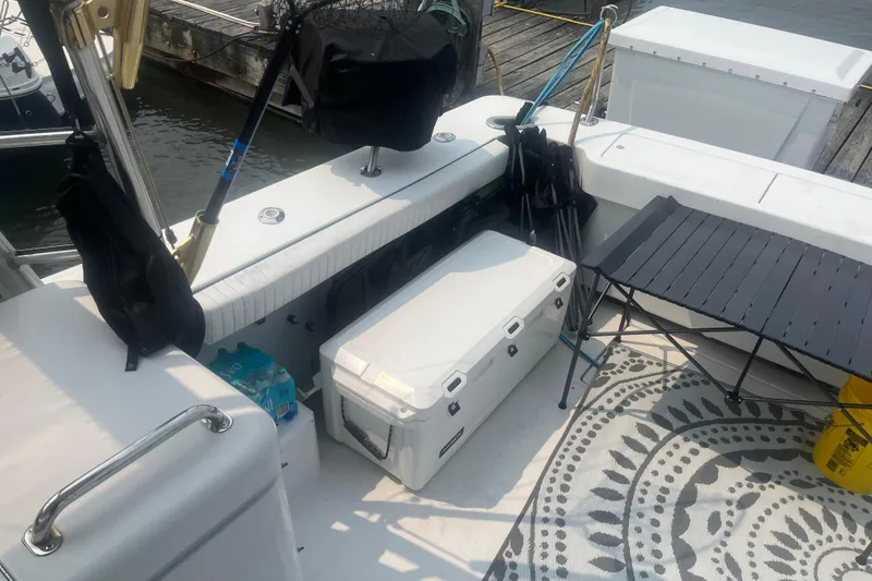 Slide: The Image of 1998 Luhrs 36 Open boat deck with cooler, table, and fishing gear. - 14