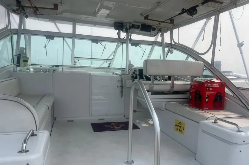 Slide: The Image of 1998 Luhrs 36 Open boat interior with seating, helm, and Craftsman toolboxes. - 4