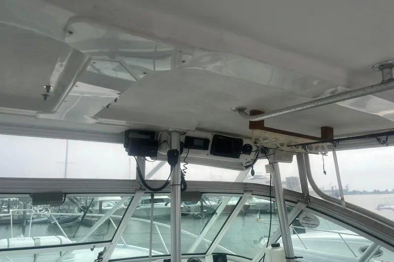 Slide: The Image of Interior view of a 1998 Luhrs 36 Open boat with visible electronics and marina background. - 5