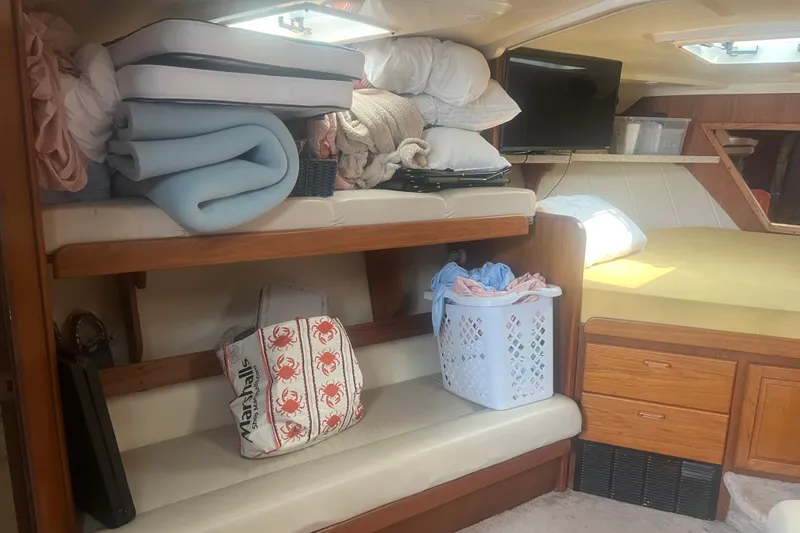 Slide: The Image of Interior of 1998 Luhrs 36 Open boat with storage, bedding, and TV. - 7