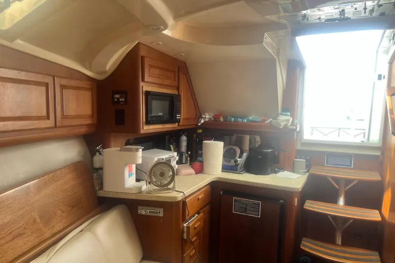 Slide: The Image of Interior of 1998 Luhrs 36 Open boat with kitchen amenities and wooden cabinetry. - 8