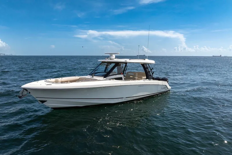 The Image of 2023 Boston Whaler 350 Realm boat on open sea under clear blue sky. - 0
