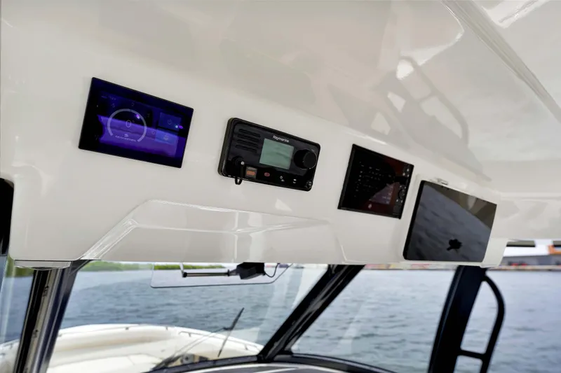 Slide: The Image of 2023 Boston Whaler 350 Realm dashboard with modern navigation and control systems. - 12