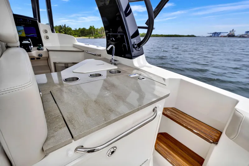 Slide: The Image of 2023 Boston Whaler 350 Realm interior with sleek countertop and ocean view. - 17