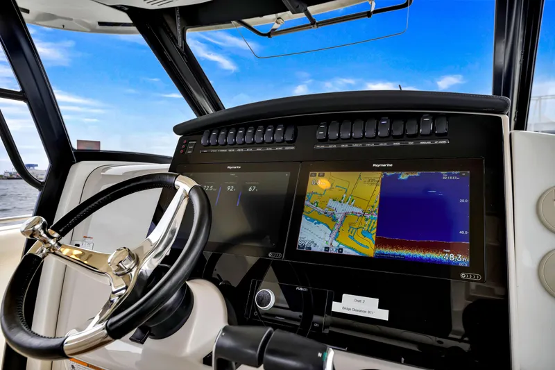 Slide: The Image of 2023 Boston Whaler 350 Realm dashboard with navigation screens and steering wheel. - 22