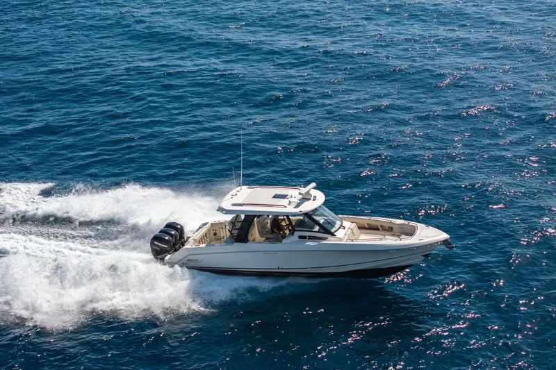 Slide: The Image of 2023 Boston Whaler 350 Realm cruising on open blue ocean waters. - 7