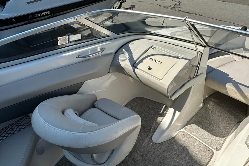 Slide: The Image of Interior of a 2006 Larson Senza 206 boat, featuring a sleek dashboard and seating. - 10