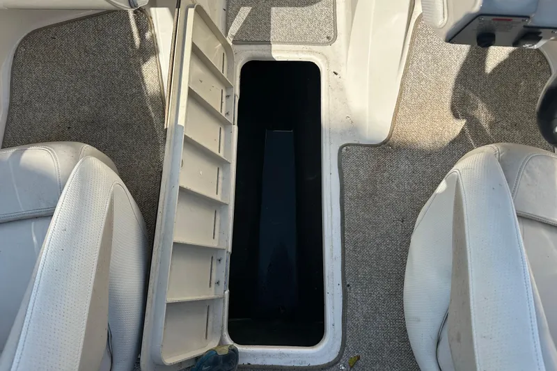 Slide: The Image of Open storage compartment in 2006 Larson Senza 206 boat interior with carpeted flooring. - 12