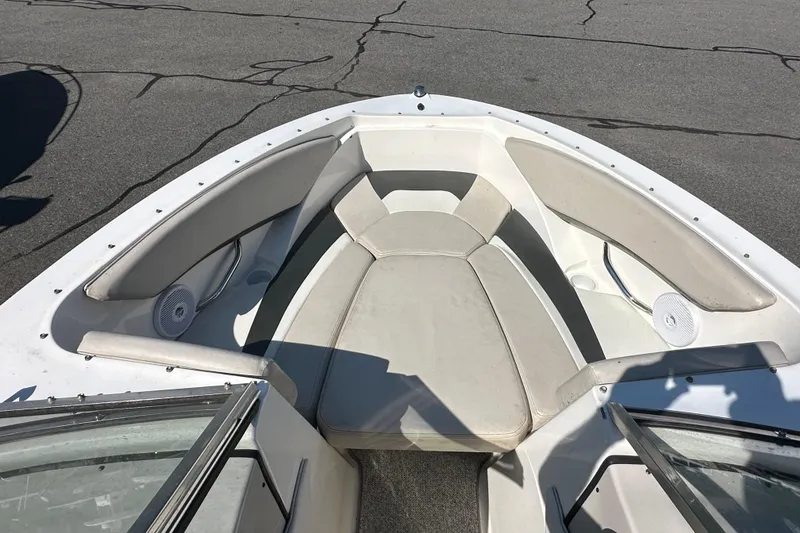 Slide: The Image of 2006 Larson Senza 206 boat interior with cushioned seating and speakers. - 13