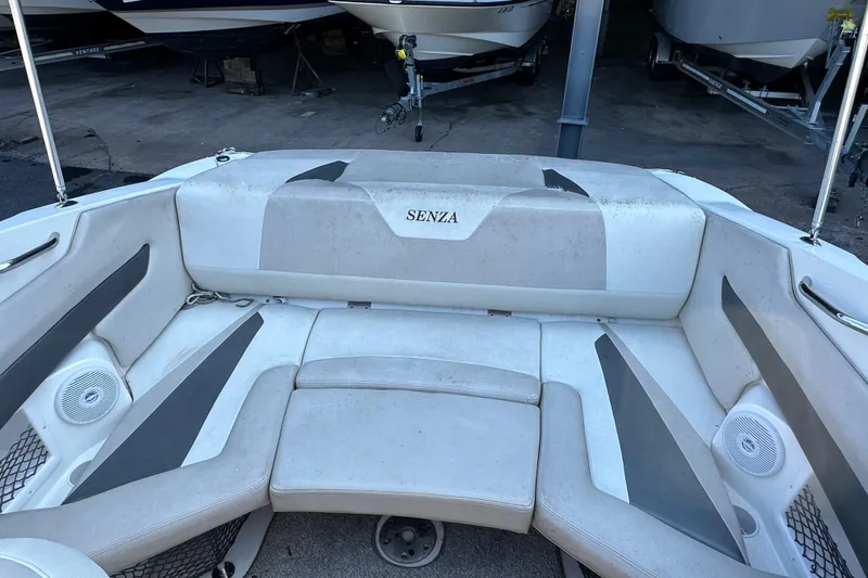 Slide: The Image of 2006 Larson Senza 206 boat interior with white and gray seating in storage. - 7