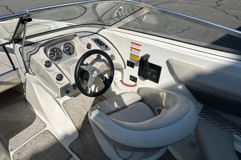 Slide: The Image of 2006 Larson Senza 206 boat interior with steering wheel and dashboard controls. - 9