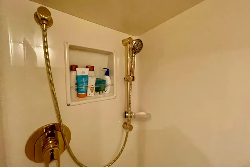 Slide: The Image of Shower area in 2005 Viking 48 Convertible yacht with toiletries and handheld showerhead. - 14