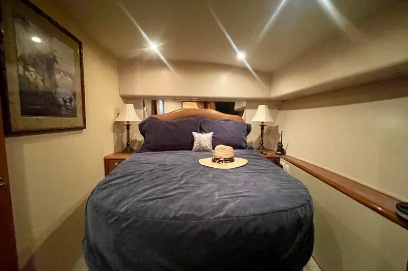 Slide: The Image of Luxurious bedroom interior of 2005 Viking 48 Convertible yacht with cozy bedding and elegant decor. - 16