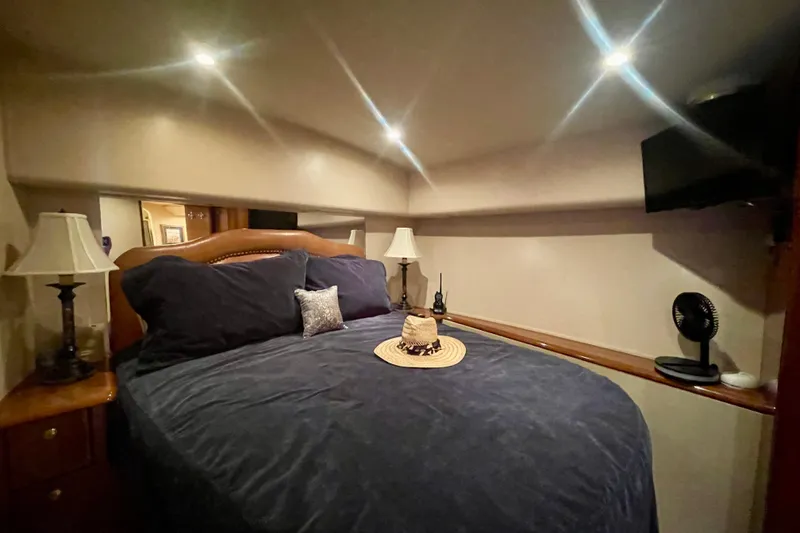 Slide: The Image of Luxurious bedroom interior of 2005 Viking 48 Convertible yacht with cozy bedding and ambient lighting. - 17