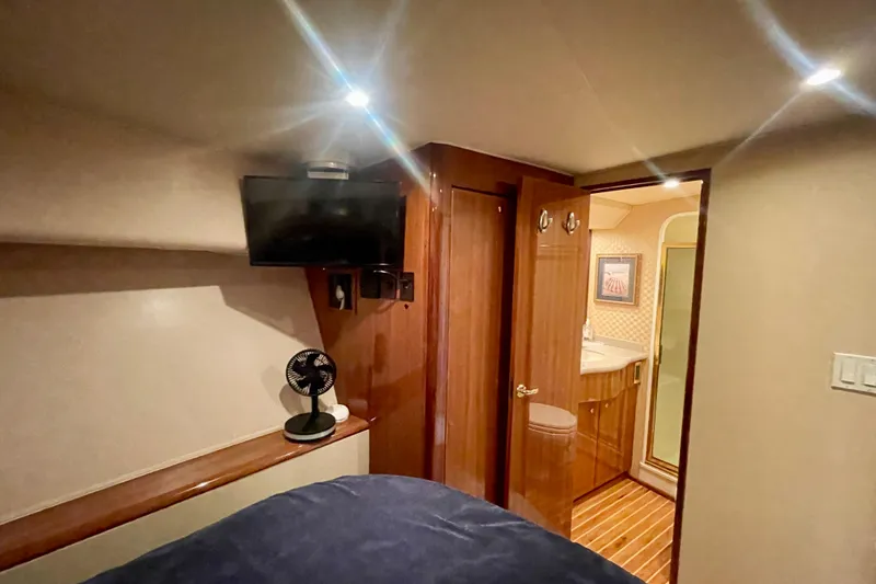 Slide: The Image of 2005 Viking 48 Convertible yacht interior with TV, fan, and bathroom. - 18