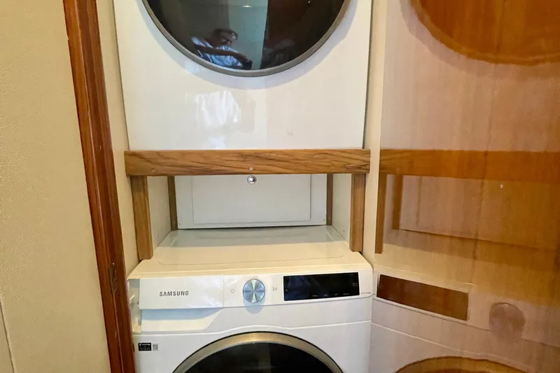 Slide: The Image of Stacked Samsung washer and dryer inside a 2005 Viking 48 Convertible yacht. - 27