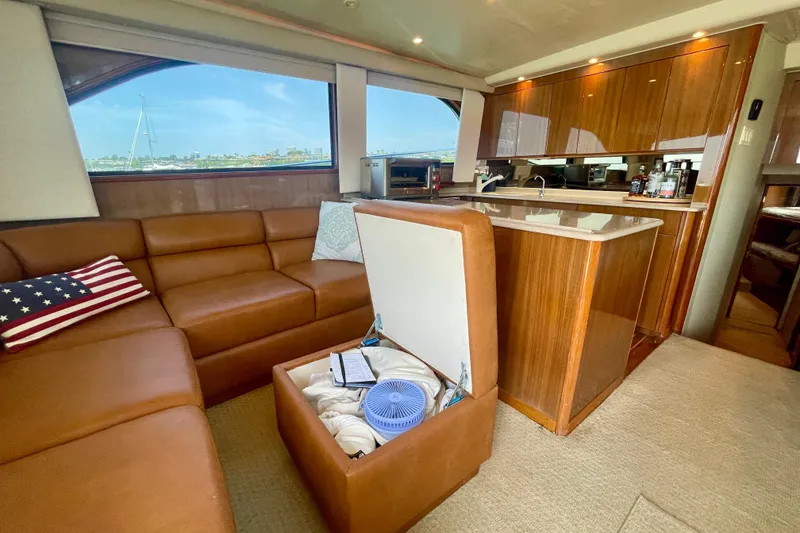 Slide: The Image of Luxurious interior of 2005 Viking 48 Convertible yacht with leather seating and wooden cabinetry. - 34