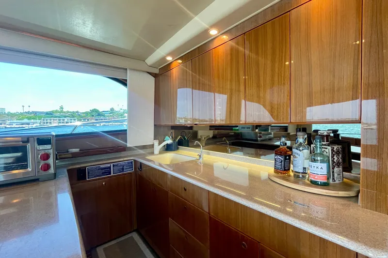Slide: The Image of Luxurious kitchen interior of 2005 Viking 48 Convertible yacht with wooden cabinets and countertop. - 36