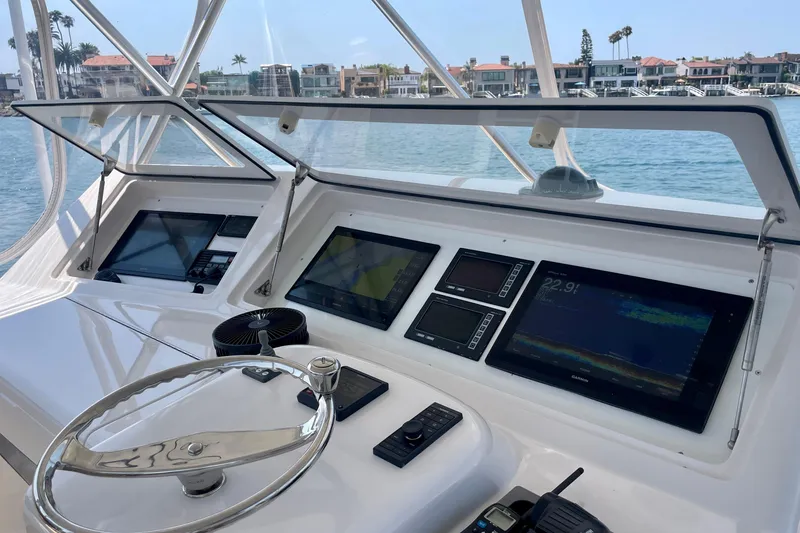 Slide: The Image of 2005 Viking 48 Convertible yacht helm with advanced navigation displays and steering wheel. - 51