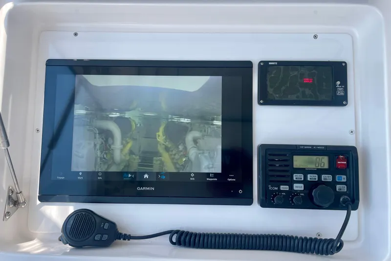 Slide: The Image of Control panel of a 2005 Viking 48 Convertible with Garmin display and communication devices. - 54