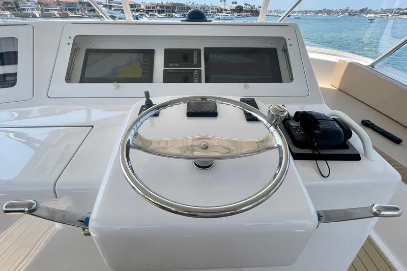 Slide: The Image of Helm of 2005 Viking 48 Convertible yacht with navigation screens and controls. - 56