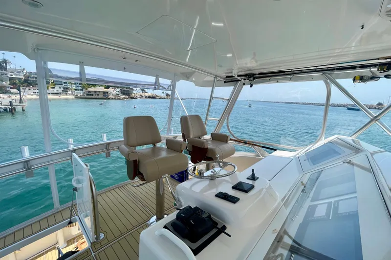 Slide: The Image of 2005 Viking 48 Convertible yacht helm with ocean view and luxurious seating. - 58