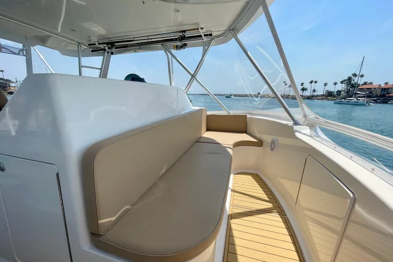 Slide: The Image of 2005 Viking 48 Convertible yacht interior with beige seating and ocean view. - 61