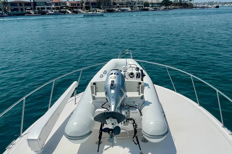 Slide: The Image of Bow view of 2005 Viking 48 Convertible yacht with inflatable boat and outboard motor. - 62