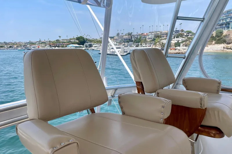 Slide: The Image of Luxury seating on 2005 Viking 48 Convertible yacht with scenic marina view. - 65