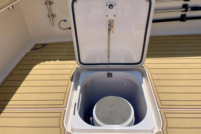 Slide: The Image of Open hatch on 2005 Viking 48 Convertible boat deck, revealing storage compartment. - 68