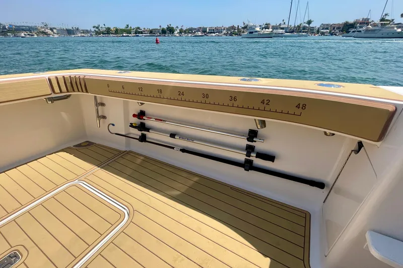 Slide: The Image of 2005 Viking 48 Convertible boat deck with fishing rod holders and measurement scale. - 72