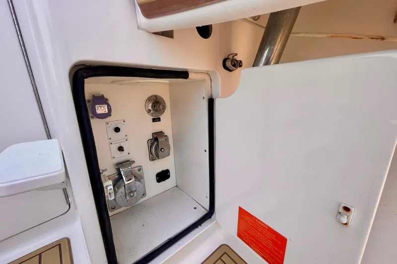 Slide: The Image of 2005 Viking 48 Convertible yacht electrical panel with various controls and connections. - 82