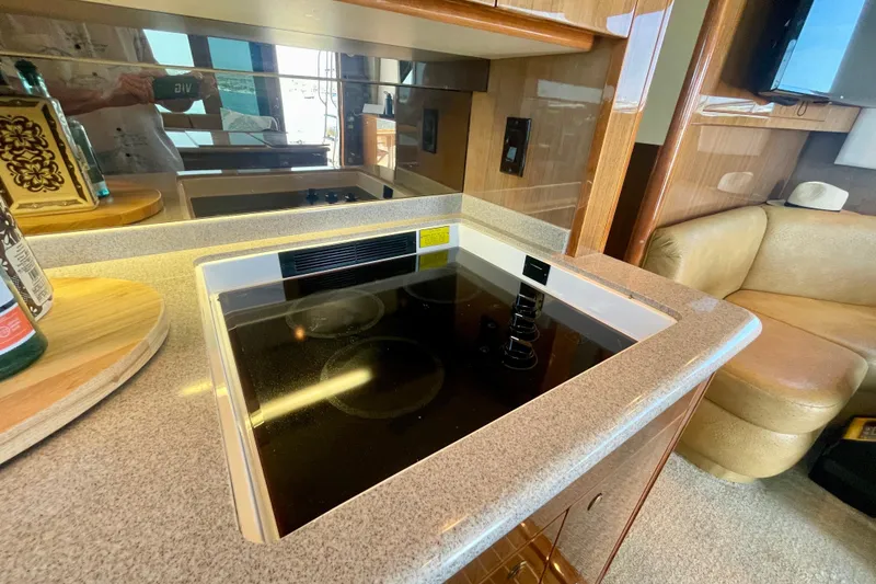 Slide: The Image of Luxurious kitchen area in a 2005 Viking 48 Convertible yacht with modern amenities. - 83