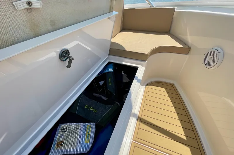 Slide: The Image of 2005 Viking 48 Convertible boat interior with storage compartment and seating area. - 84
