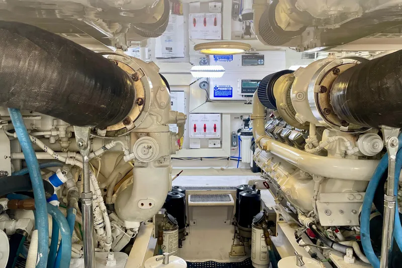 Slide: The Image of Engine room of a 2005 Viking 48 Convertible yacht, showcasing dual engines and control systems. - 85