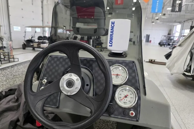 Slide: The Image of 2016 Tracker Pro 160 boat dashboard with steering wheel and Lowrance device. - 3