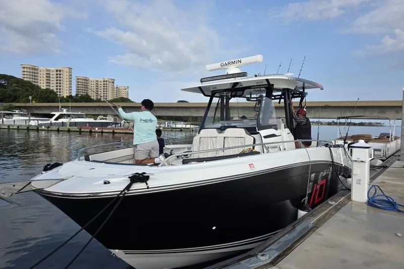The Image of 2024 Jeanneau Leader 10.5 CC boat docked at marina with people onboard. - 0
