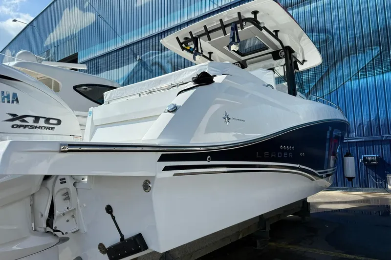 Slide: The Image of 2024 Jeanneau Leader 10.5 CC boat with Yamaha XTO Offshore engine, docked outdoors. - 12