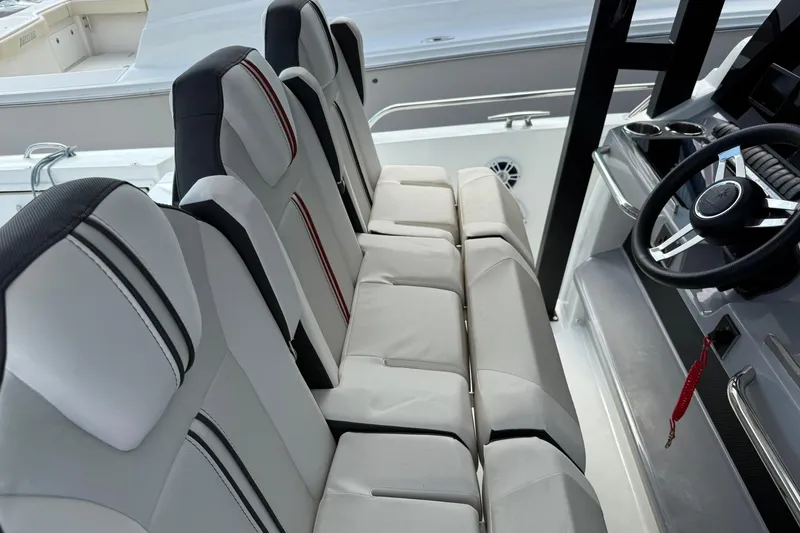 Slide: The Image of 2024 Jeanneau Leader 10.5 CC boat interior with modern seating and steering wheel. - 14