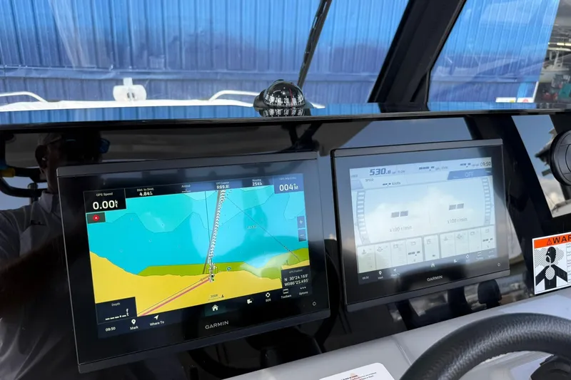 Slide: The Image of 2024 Jeanneau Leader 10.5 CC dashboard with Garmin navigation displays. - 15