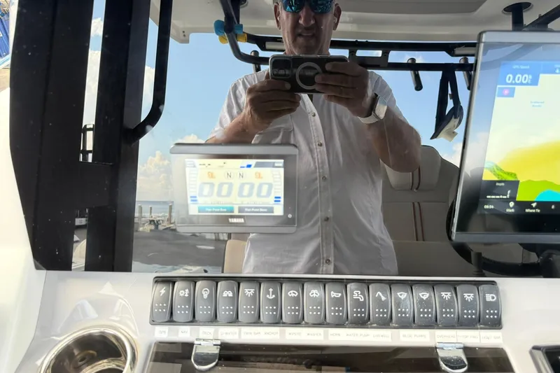 Slide: The Image of 2024 Jeanneau Leader 10.5 CC dashboard with digital displays and control panel. - 16