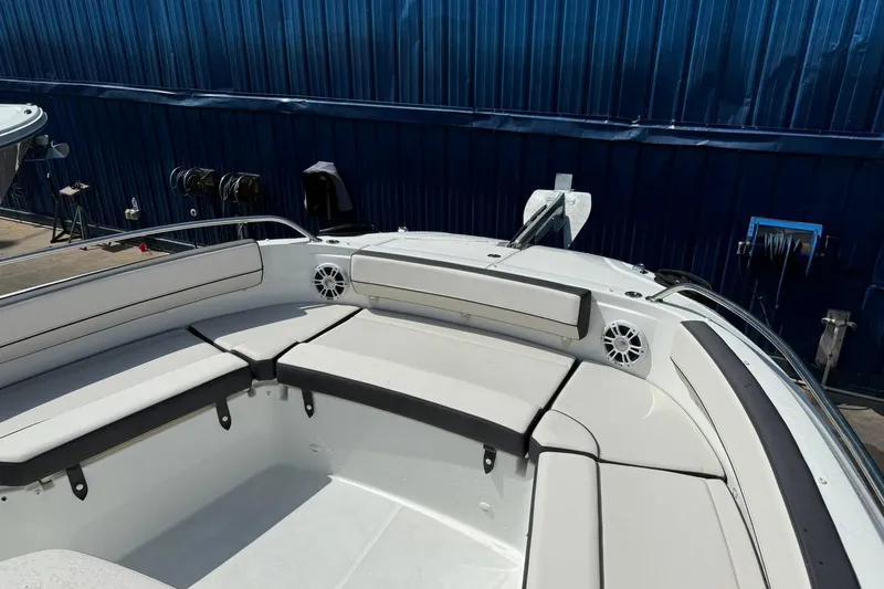 Slide: The Image of 2024 Jeanneau Leader 10.5 CC boat interior with cushioned seating and speakers. - 18