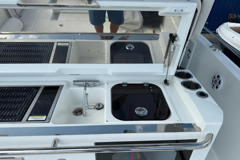 Slide: The Image of 2024 Jeanneau Leader 10.5 CC boat kitchen area with sink and grill. - 22